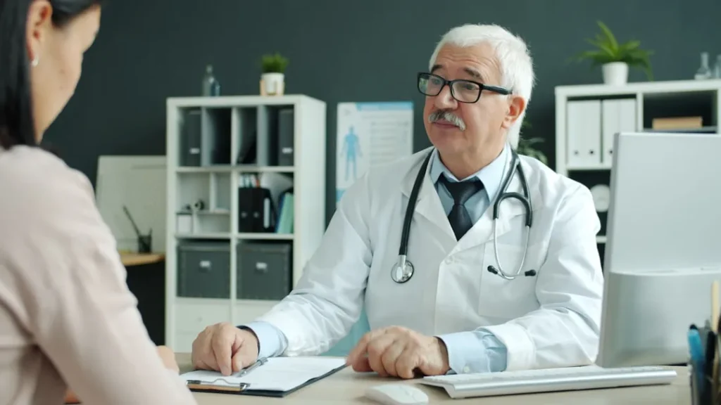 Doctor consults with patient in modern office.