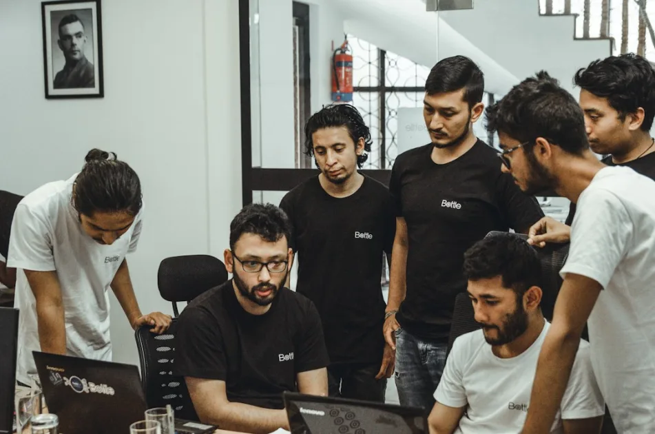 people near a black top computer in a room