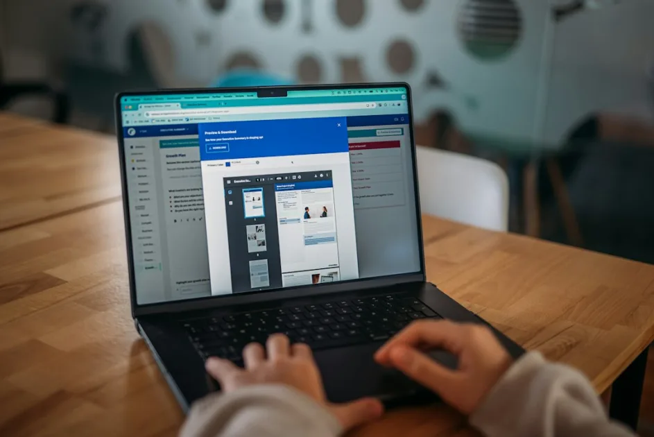 Someone is working on a laptop, viewing a presentation